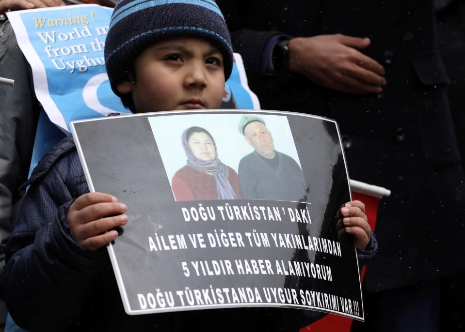 A Uyghur boy holds a placard that reads: "I cannot have any news from my family and relatives in Eastern Turkistan", during a protest near the Chinese embassy in Ankara, Turkey, on March 25.