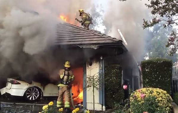 Firefighters battle a blaze sparked by a Tesla in Lake Forest, Calif., on Aug. 25, 2017. (Orange County Fire Authority)