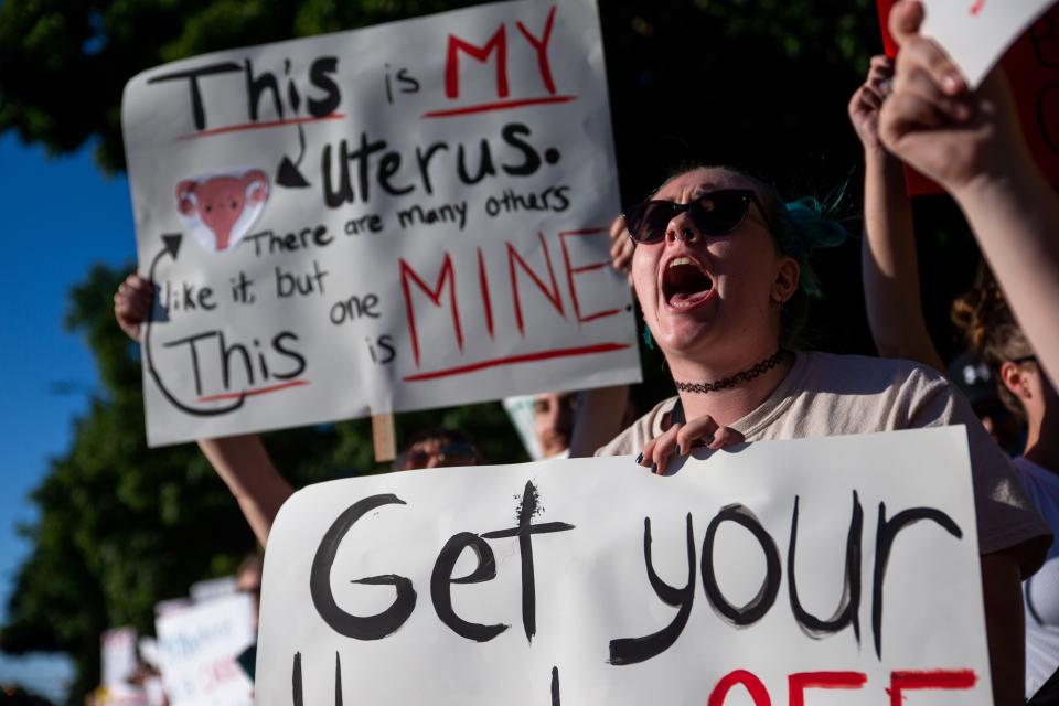 Protestors gather in Centennial Park to protest the reversal of Roe v. Wade on Monday, June 27, 2022, in downtown Holland.