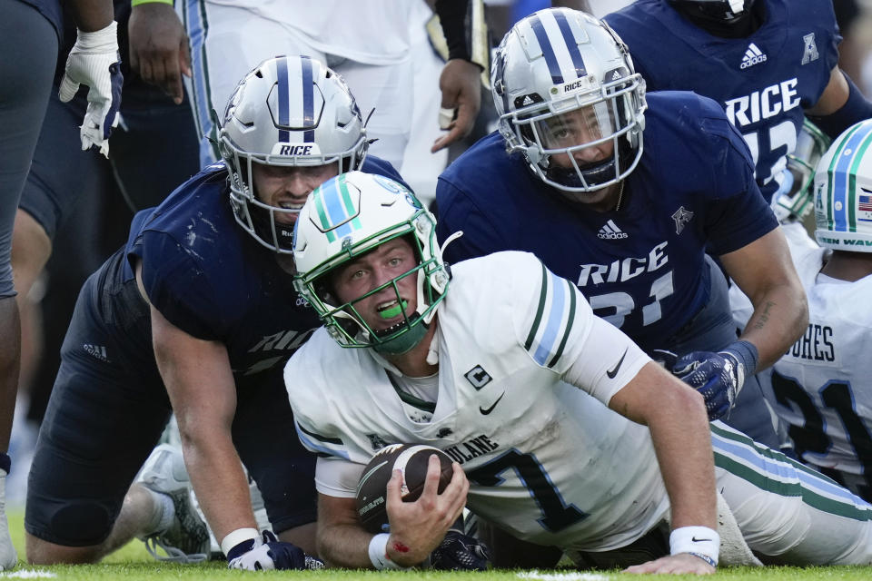 Tulane quarterback Michael Pratt, center, looks to the sideline to see if he made a first down after rushing on fourth down during the second half of an NCAA college football game against Rice, Saturday, Oct. 28, 2023, in Houston. Pratt converted for a first down. (AP Photo/Eric Christian Smith)