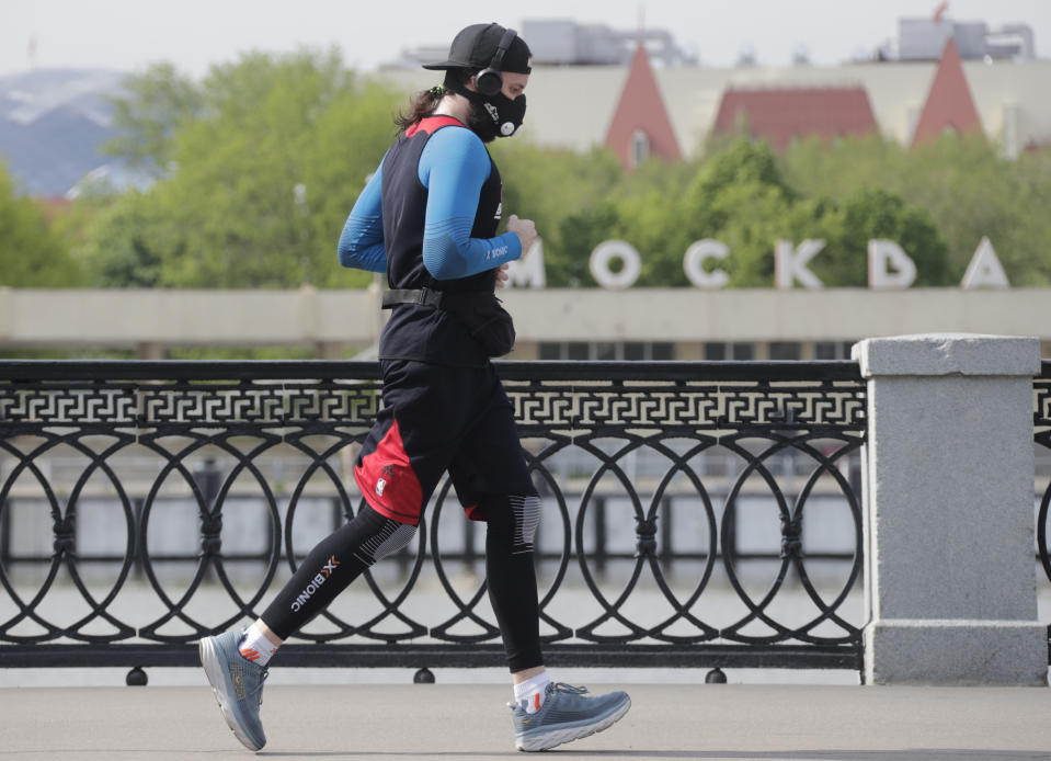 MOSCOW, RUSSIA - MAY 27, 2020: A man jogs by the Moskva River amid the ongoing COVID-19 pandemic. The self-isolation regime in Russia is extended until 31 May in order to prevent the spread of the novel coronavirus. Mikhail Metzel/TASS (Photo by Mikhail Metzel\TASS via Getty Images)