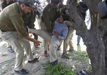 Policemen detain a supporter believed to be a pro-Telangana activist during a protest outside parliament in New Delhi February 13, 2014. REUTERS/Anindito Mukherjee