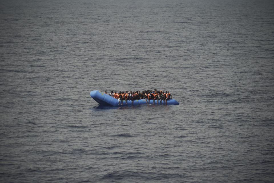 FILE - In this Sept. 17, 2019, file photo, migrants aboard a blue plastic boat are seen in the Mediterranean Sea. The U.N. refugee agency is investigating why Malta last week allegedly asked the Libyan coast guard to intercept a migrant boat in a zone of the Mediterranean under Maltese responsibility, in possible violation of maritime law, a U.N. official said Tuesday, Oct. 22, 2019. (AP Photo/Renata Brito)