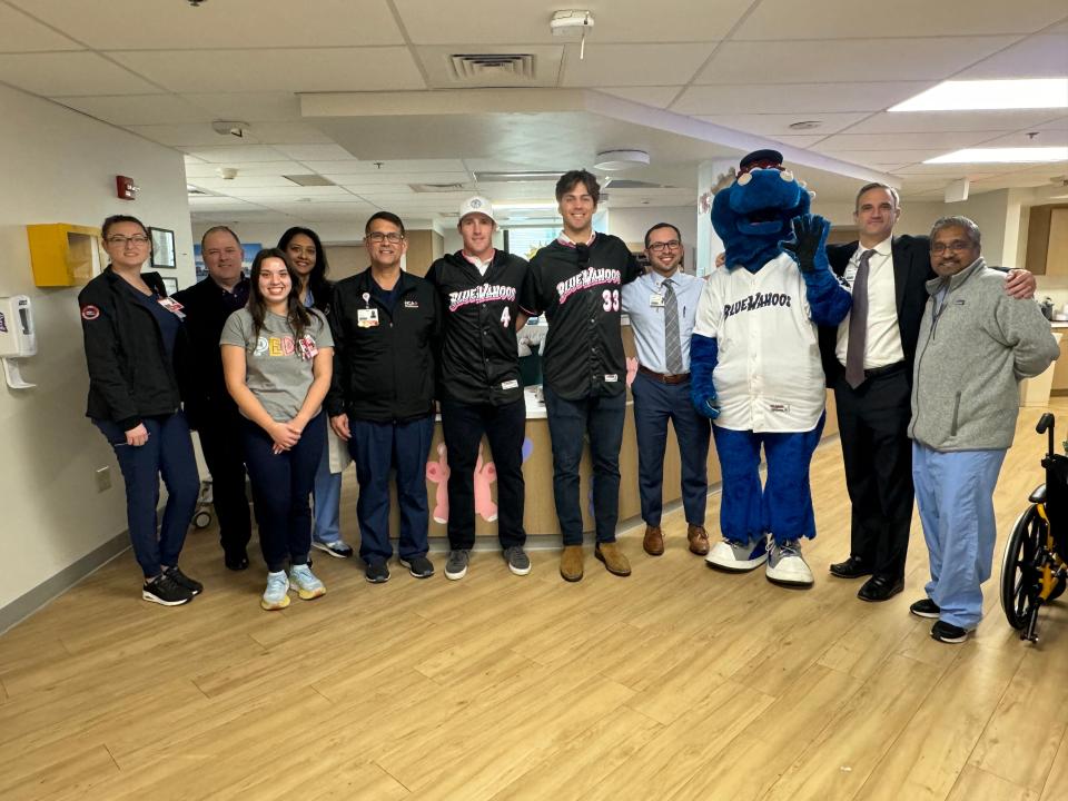 Pensacola Blue Wahoos players Jacob Berry (4) and Ike Buxton (33) meet with hospital staff members before visiting some patients at the HCA Florida West Hospital on Thursday, Jan. 18, 2024.