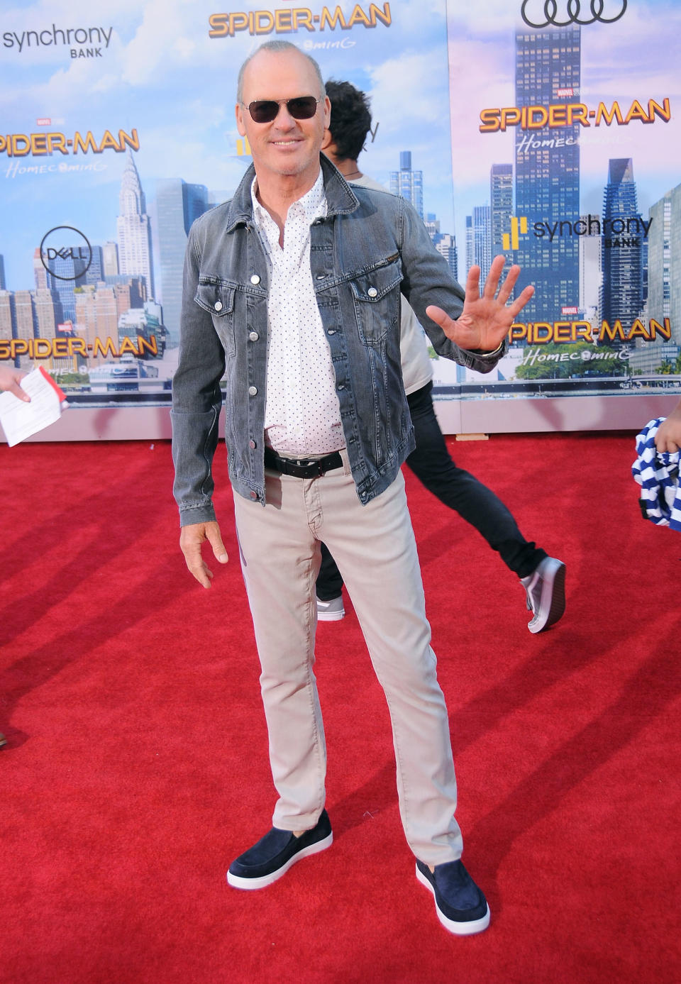 Full length shot of Michael wearing a blue-grey denim jacket, white shirt with black dots, stone coloured jeans and pumps at the Spider-Man: Homecoming premiere.