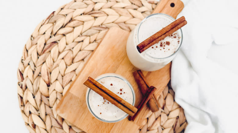 horchata with cinnamon stick garnish on cutting board