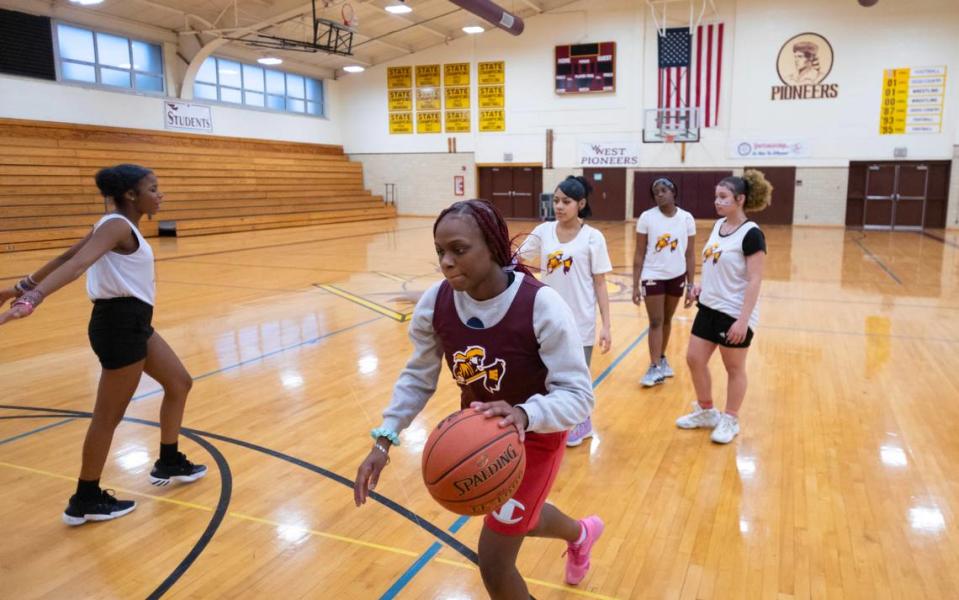 Members of the West High girls basketball team practice at the school on Tuesday. The team had to forfeit the remaining games on their schedule due to often not having enough players. Despite having no games to play, the remaining girls still come to practice every day.
