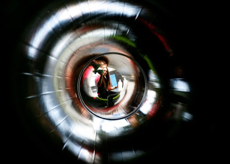 FILE PHOTO: Woman cleans inside of exhibit representing natural gas pipeline during final preparations at the Hannover Messe industrial trade fair in Hannover