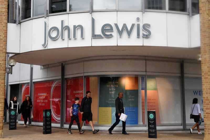 Shoppers are seen walking past a John Lewis store, in London