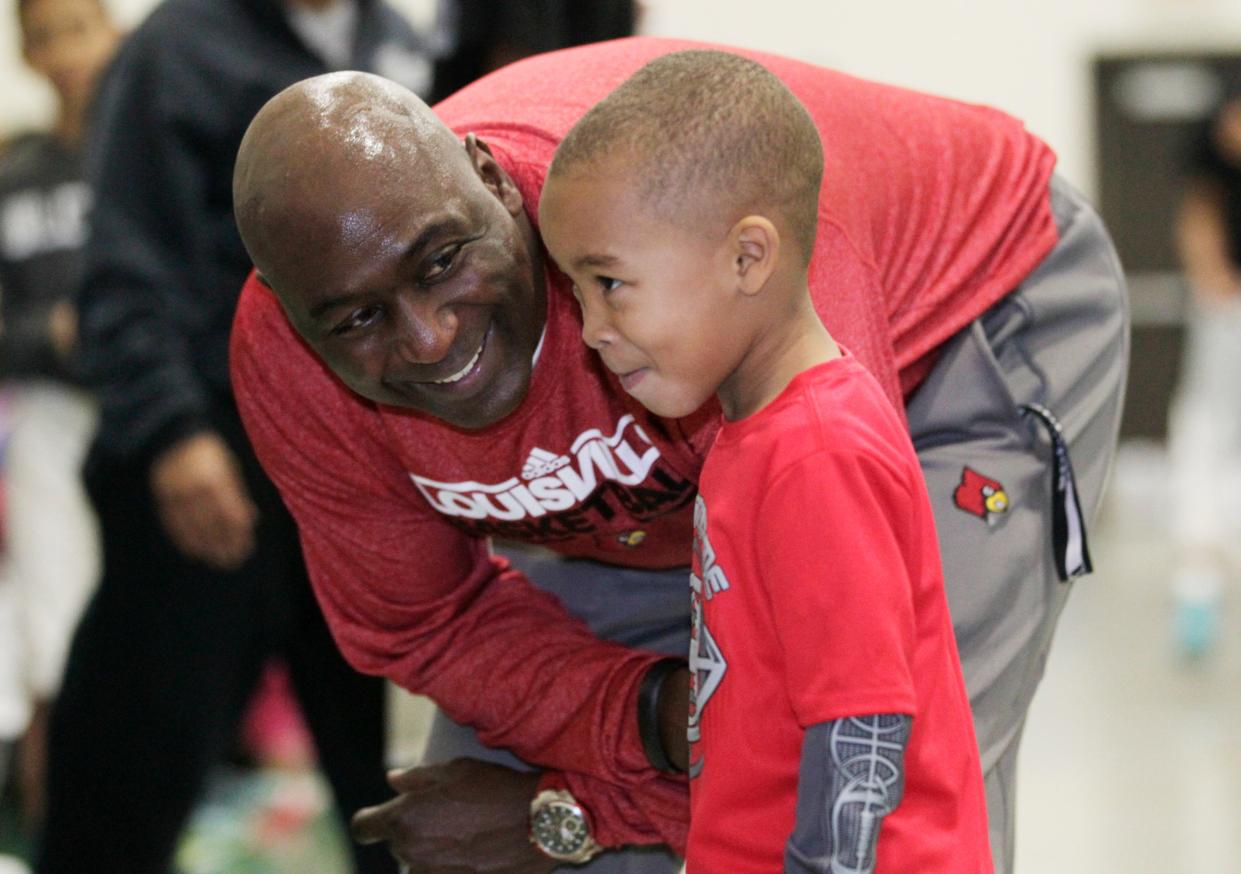 Former University of Louisville basketball player Robbie Valentine talks with Khalen Hadley (4) during a free Sports Leadership Camp for youth at the at South Louisville Community Center in Louisville, Kentucky, December 27, 2014.