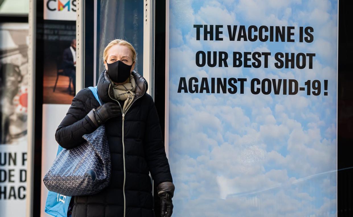 <span class="caption">A woman walks by a sign in New York City amid the coronavirus pandemic on March 30, 2021.</span> <span class="attribution"><a class="link " href="https://www.gettyimages.com/detail/news-photo/person-walks-by-a-sign-that-reads-the-vaccine-is-our-best-news-photo/1310072796?adppopup=true" rel="nofollow noopener" target="_blank" data-ylk="slk:Noam Galai/Getty Images;elm:context_link;itc:0;sec:content-canvas">Noam Galai/Getty Images</a></span>