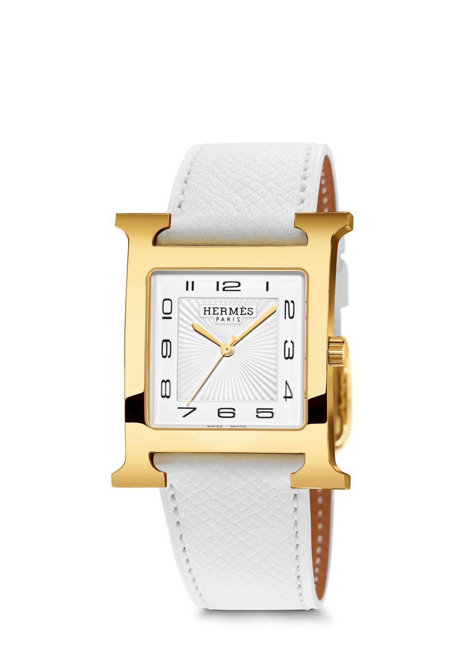 Heure H in yellow gold on white Epsom calfskin strap, £2,330, Hermès