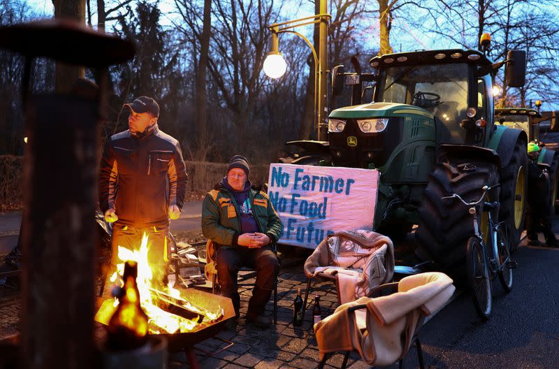 German farmers prepare for a protest against the cut of farm vehicle tax subsidies in Berlin