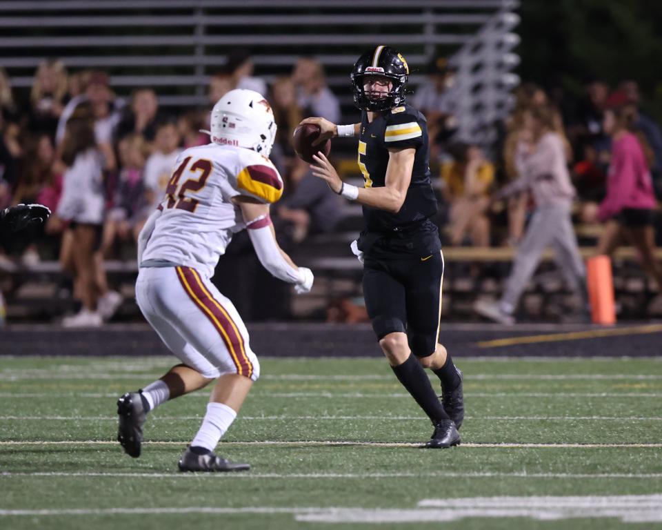 Ankeny's Nolan Morrison (42) pressures Southest Polk's Connor Moberly (5) at Southeast Polk High School.