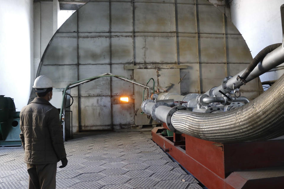 An employee of the Sangwon Cement Complex watches operations in Sangwon county, North Hwanghae Province, North Korea, on Nov. 5, 2020. North Korea is staging an “80-day battle,” a propaganda-heavy productivity campaign meant to bolster its internal unity and report greater production in various industry sectors ahead of a ruling party congress in January. (AP Photo/Jon Chol Jin)