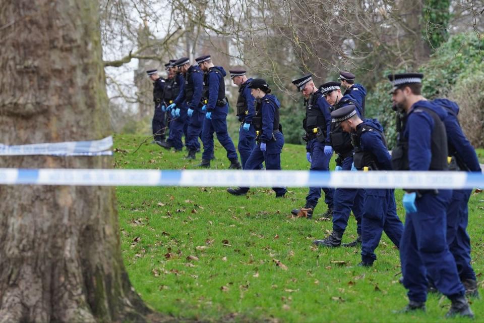 Police officers conduct a fingertip search on Primrose Hill on Monday (PA)