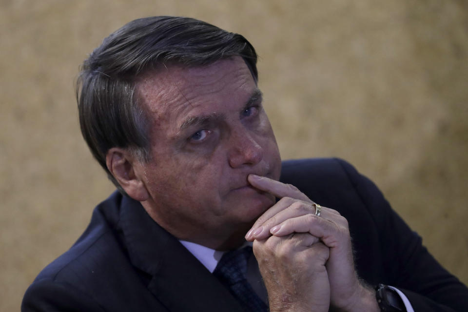 FILE - Brazil's President Jair Bolsonaro attends the launch of the Mining and Development Program, at the headquarters of the Ministry of Mines and Energy, in Brasilia, Brazil, Sept. 28, 2020. Bolsonaro’s administration introduced legislation that would open up Indigenous territories to mining — something federal prosecutors have called unconstitutional and activists warn would wreak vast social and environmental damages. (AP Photo/Eraldo Peres, File)