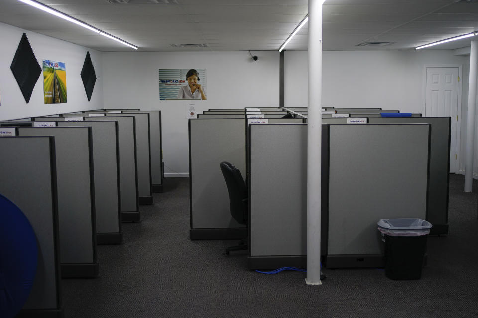 Unattended work stations fill the Teleworks USA job site Beattyville, Ky., Wednesday, July 29, 2020. The center is left dormant because of COVID-19 health concerns. (AP Photo/Bryan Woolston)