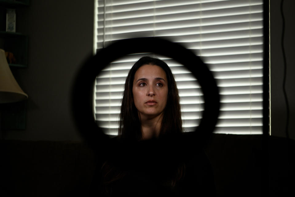 Gina Kuehne with a ring light, which she uses to hold her phone while making product review videos, at her home in Texas. (Callaghan O'Hare for The Washington Post)