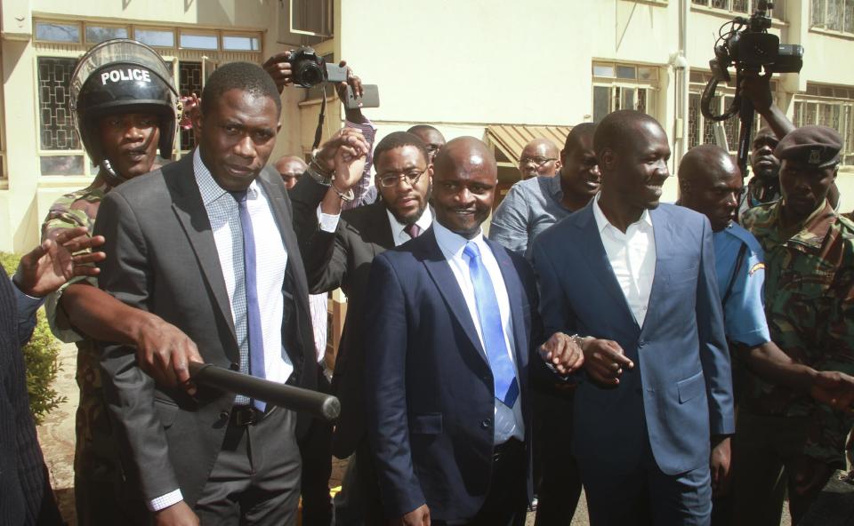 Kenya doctors union Secretary General Dr. Ouma Oluga, left, Chairman Dr. Samuel Oroko, center, and Vice-Chairman Dr Allan Ochanji, right, are taken away to a police vehicle after a court hearing in Nairobi, Kenya Monday, Feb. 13, 2017. A Kenyan judge has jailed seven officials of the medics union for failing to call off a two-month strike by doctors at public hospitals that has seen at least a dozen die due to lack of medical care. (AP Photo)