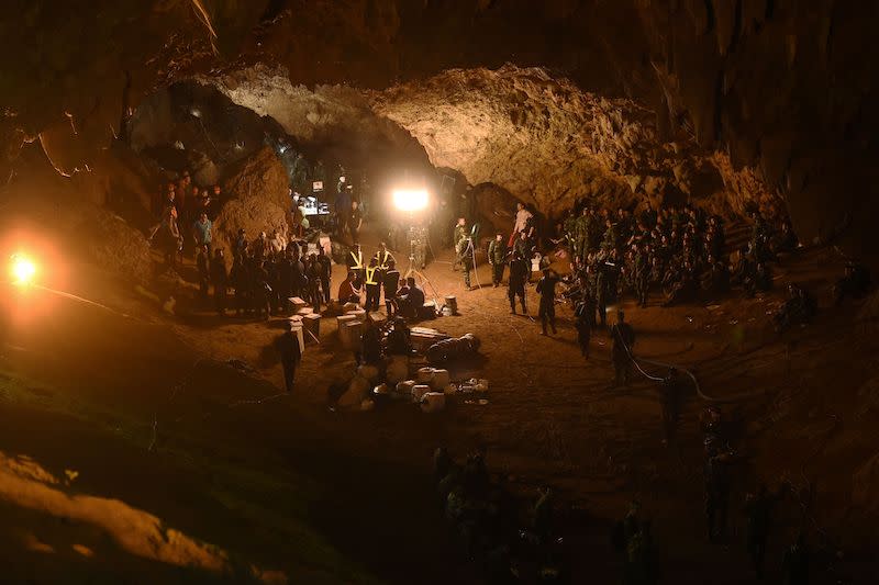 <p>Thai soldiers relay electric cable deep into the Tham Luang cave at the Khun Nam Nang Non Forest Park in Chiang Rai, Thailand on June 26, 2018 during a rescue operation for a missing children’s football team and their coach. Desperate parents led a prayer ceremony outside a flooded cave in northern Thailand where 12 children and their football coach were trapped for days, as military rescue divers packing food rations resumed their search on June 26. (Photo from Lillian Suwanrumpha/AFP/Getty Images) </p>