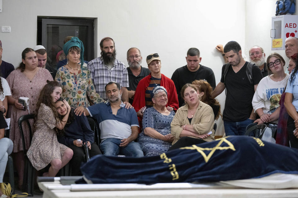 Mourners attend the funeral of Batsheva Nigri, at a cemetery in the West Bank Jewish settlement of Kfar Etzion, Monday, Aug. 21, 2023. Israeli authorities say that a suspected Palestinian attacker has killed an Israeli woman and seriously wounded a man in the incident. (AP Photo/Ohad Zwigenberg)