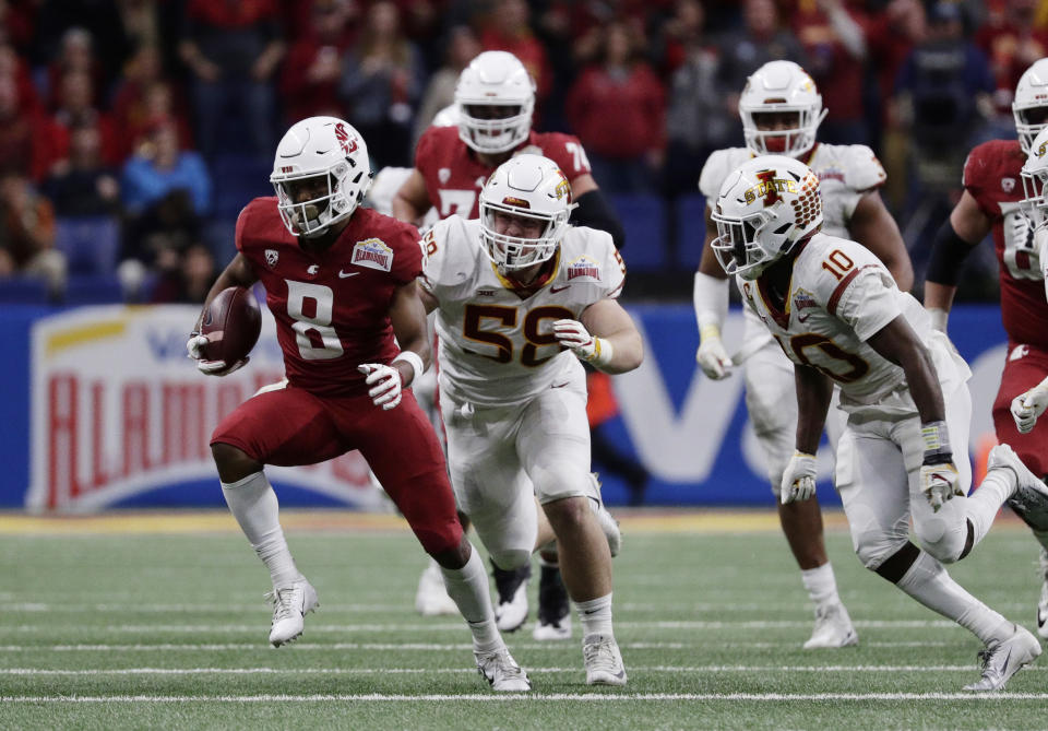 Washington State wide receiver Easop Winston (8) runs past Iowa State defensive end Spencer Benton (58) after making a catch during the second half of the Alamo Bowl NCAA college football game Friday, Dec. 28, 2018, in San Antonio. (AP Photo/Eric Gay)
