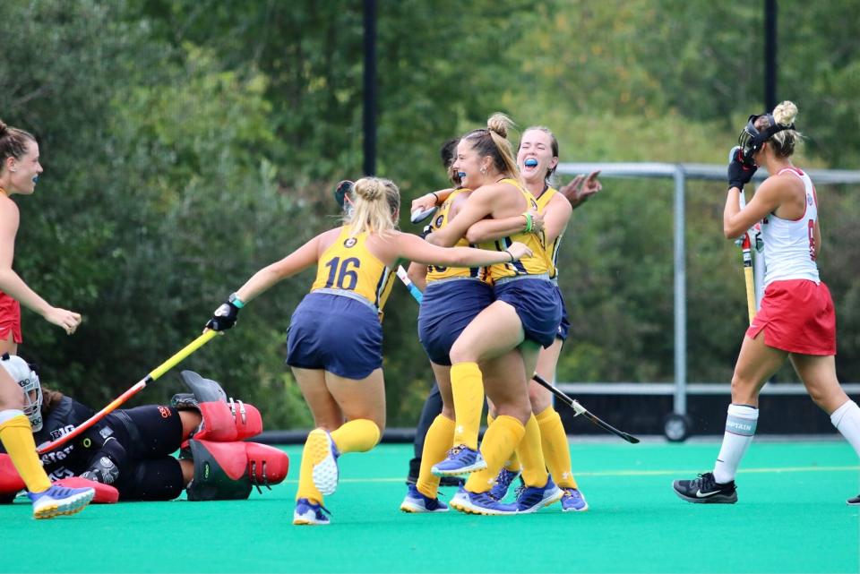 Members of Kent State's field hockey team celebrate a 2021 victory over Miami. The Golden Flashes and RedHawks shared the 2021 regular season title.