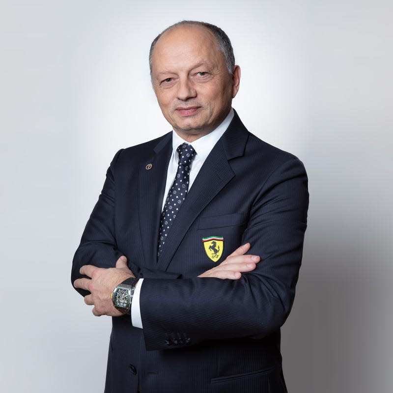 Fred Vasseur in a suit jacket with a Ferrari patch on the pocket.