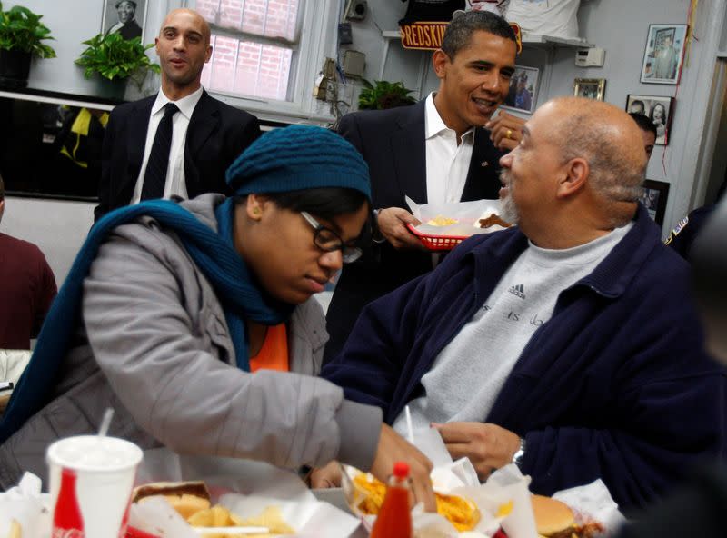 FILE PHOTO: U.S. President-elect Barack Obama picks up his food order during lunch with Mayor Adrian Fenty in Washington