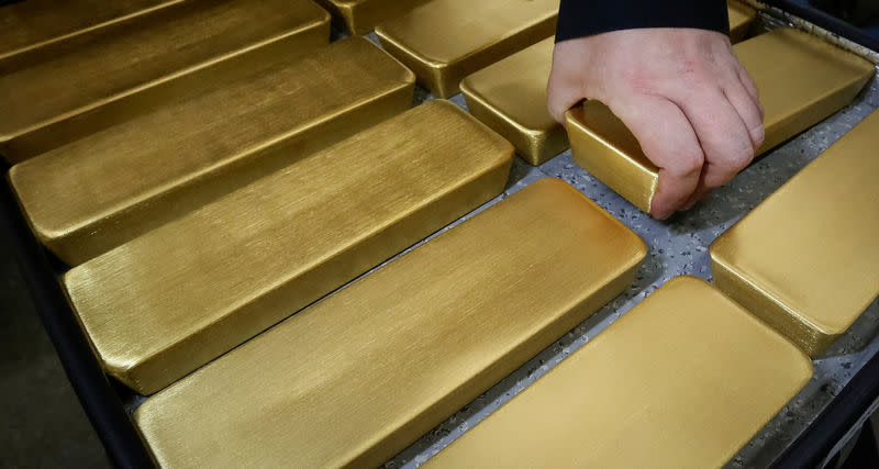 An employee stores newly casted ingots of 99.99 percent pure gold after weighing at the Krastsvetmet non-ferrous metals plant, one of the world's largest producers in the precious metals industry, in the Siberian city of Krasnoyarsk, Russia November 22, 2018. Picture taken November 22, 2018. REUTERS/Ilya Naymushin