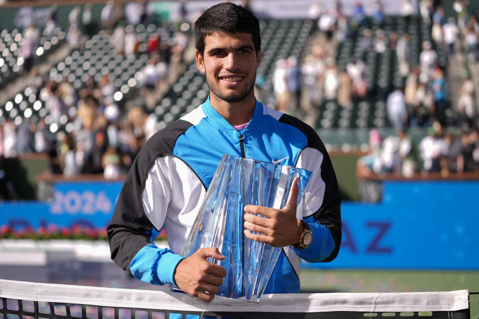 Carlos Alcaraz, of Spain, holds the trophy after defeating Daniil Medvedev, of Russia, in the final match at the BNP Paribas Open tennis tournament, Sunday, March 17, 2024, in Indian Wells, Calif. (AP Photo/Ryan Sun)