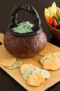 <p>Impress guests with this appetizer that cleverly transforms pumpernickel bread and breadsticks. Fill it with a super-simple creamy spinach dip and you're set. </p><p><strong><a rel="nofollow noopener" href="https://www.womansday.com/food-recipes/food-drinks/recipes/a10930/spooky-spinach-dip-in-bread-bowl-cauldron-recipe-122179/" target="_blank" data-ylk="slk:Get the recipe;elm:context_link;itc:0;sec:content-canvas" class="link ">Get the recipe</a>. </strong></p>