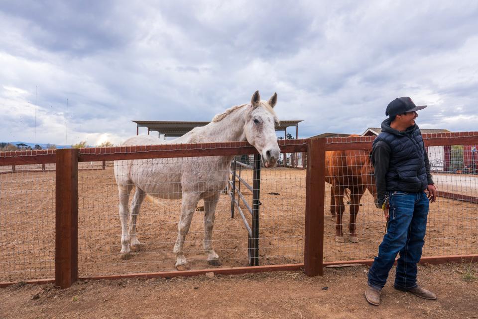 Student Giovanny Landeros tends to the horses at Rancho Cielo.