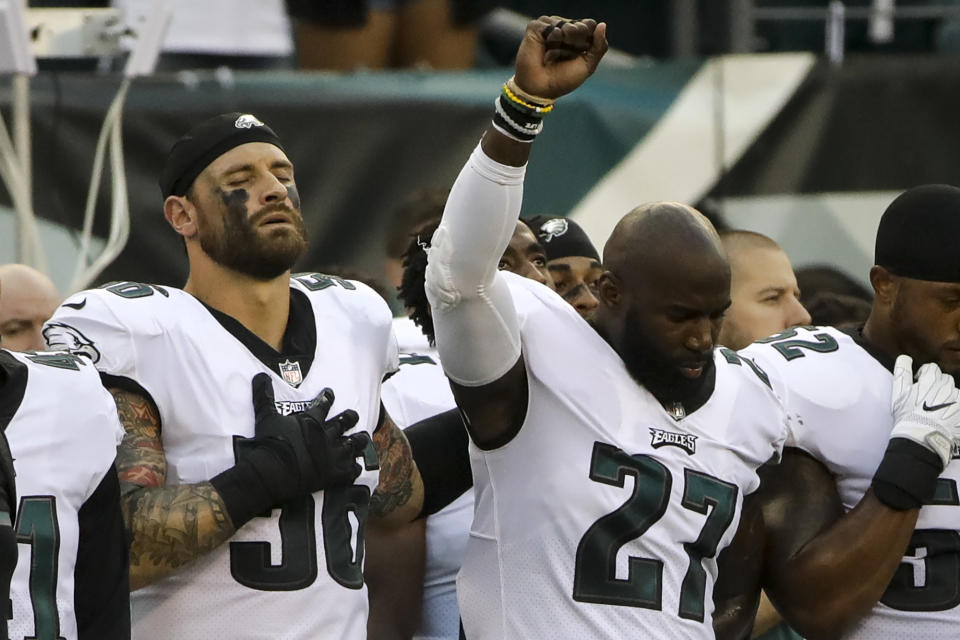 Philadelphia Eagles' Chris Long (56) stands beside Malcolm Jenkins (27) as he raises his fist during the national anthem before a preseason game. (AP)