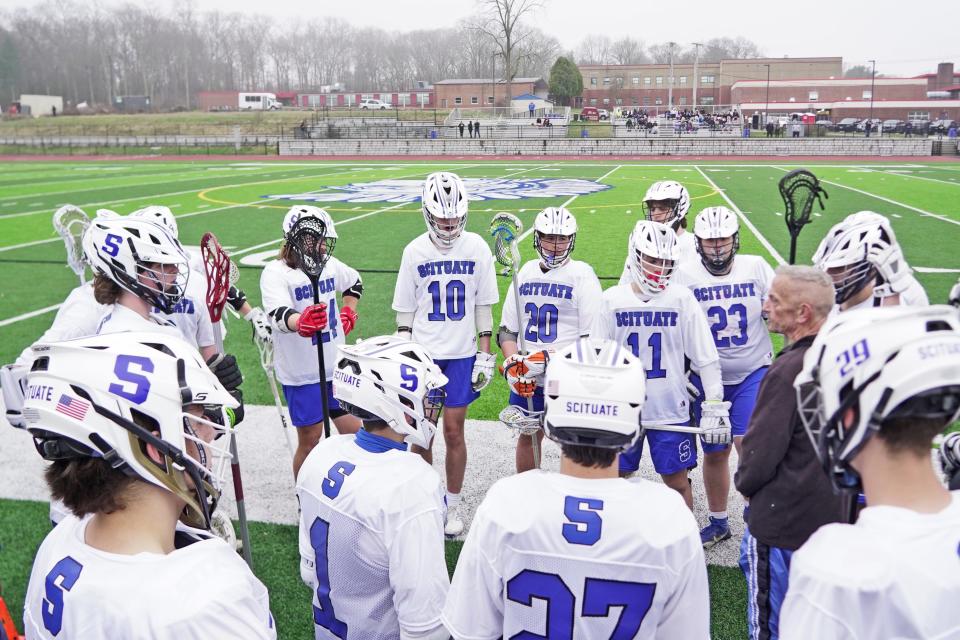 The Scituate boys lacrosse team gather on the sideline of Caito Field following its 14-8 win over Scituate Thursday, the first game played on the high school's turf field since 2021.