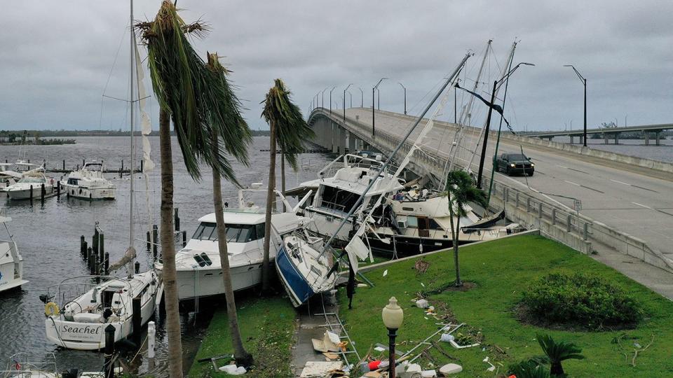 Boats are pushed up on a causeway after Hurricane Ian passed through the area on September 29, 2022, in Fort Myers, Florida.