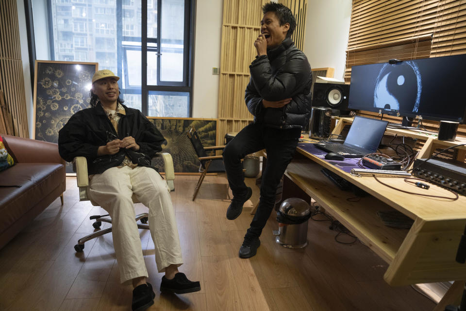 Chinese rappers Fulai, left and Kidway react during an interview in Chengdu in southwestern China's Sichuan province, Saturday, March 16, 2024. China's rap industry is flourishing, after a pause in 2018 that left many wondering if it'd be banned by the country's powerful censors. By staying clear of the government's red lines, the genre's explosive growth is able to continue. (AP Photo/Ng Han Guan)