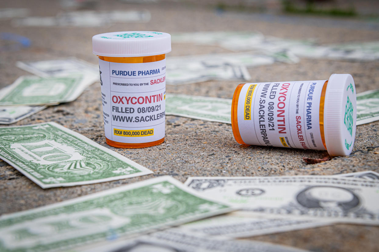 MANHATTAN, NEW YORK, UNITED STATES - 2021/08/09: Oxy Dollars and prescription bottles of OxyContin seen dropped outside the courthouse. Members of P.A.I.N. (Prescription Addiction Intervention Now), Truth Pharm, and a coalition of survivors and advocacy groups working in response to the overdose crisis held a demonstration outside of The United States Bankruptcy Court in White Plains to call out the United States justice system for allowing the billionaire Sackler Family to walk away unscathed after igniting one of the worst public health care scandals in the history of the nation. (Photo by Erik McGregor/LightRocket via Getty Images)