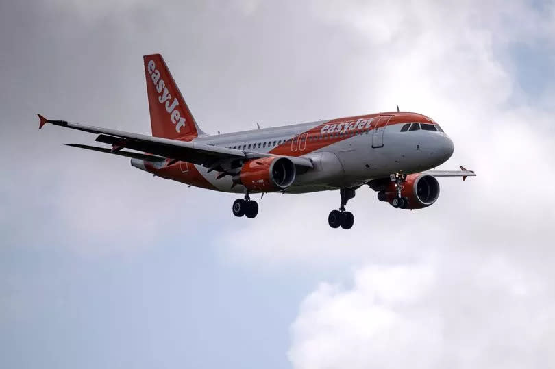 An easyjet plane in the sky at Gatwick Airport