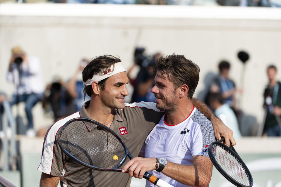 Roger Federer (pictured left) and Stan Wawrinka (pictured right) embrace.