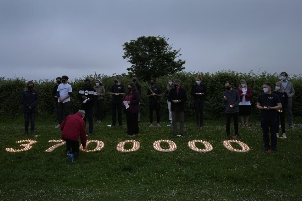 Campaigners attend a vigil to remember the millions who have died during the COVID-19 pandemic, organised by 'Crack the Crisis Coalition' in Falmouth, Cornwall, England, Friday, June 11, 2021. Leaders of the G7 began their first of three days of meetings on Friday in Carbis Bay, in which they will discuss COVID-19, climate, foreign policy and the economy. (AP Photo/Kirsty Wigglesworth)