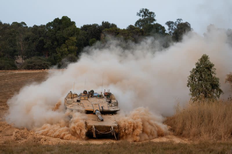 An Israeli tank maneuvers near the Israel-Gaza border before it enters Gaza, amid the Israel-Hamas conflict