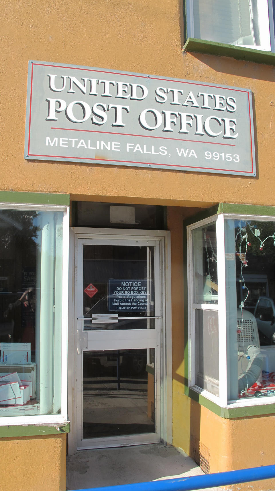 This Wednesday, July 31, 2019 photo shows the entrance to the small post office in tiny Metaline Falls, Wash. The Pend Oreille Mine near Metaline Falls has closed, costing the rural community some 200 good-paying jobs. (AP Photo/Nicholas K. Geranios)