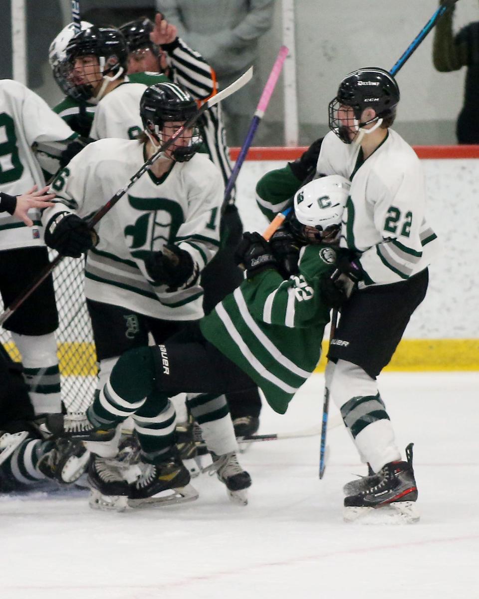 Duxbury's David Pittenger grabs the head of Canton’s Travis Thomas while jostling in front of the net during second period action of their game in the Division 2 state semifinal at Gallo Ice Arena in Bourne on Saturday, March 11, 2023.