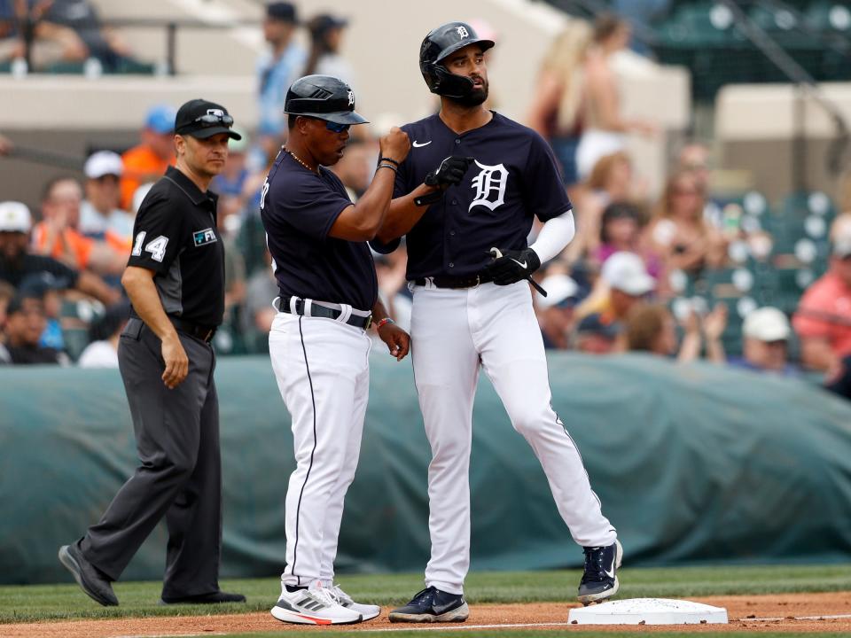 Tigers outfielder Riley Greene with third base coach Ramon Santiago after hitting a triple against the Yankees in the third inning during spring training at Publix Field at Joker Marchant Stadium on Friday, April 1, 2022. Greene had fouled a pitch off his right foot earlier in the at-bat and suffered a fracture.