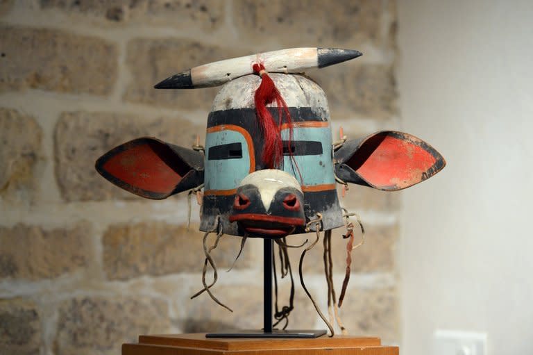 The "Wakaskatsina" sacred mask of Arizona's Hopi Indian tribe, April 5, 2013 in Paris. Around 70 brightly colored "Kachina" visages and headdresses are due to go under the hammer in a sale, also scheduled for Friday, by Neret-Minet. But Tribal peoples' advocacy group Survival International has filed a court action in Paris in an effort to halt the sale