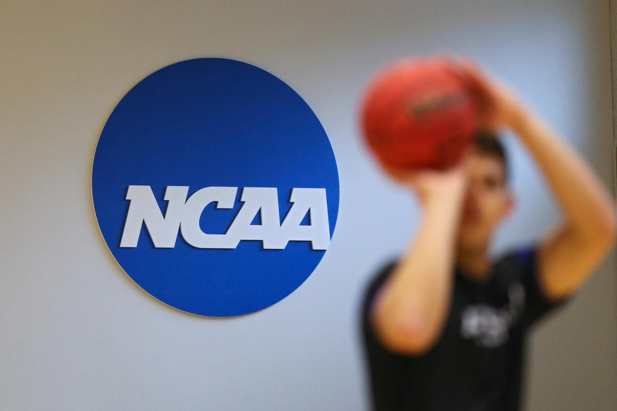 An NCAA logo is seen on the wall as players warm up prior to the NCAA Division III Men's Basketball Championship on March 6, 2020. (Patrick Smith/Getty Images)