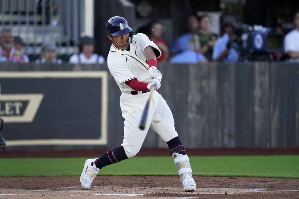 Chicago Cubs' Seiya Suzuki hits a one-run double against the Cincinnati Reds during a baseball game at the Field of Dreams movie site, Thursday, Aug. 11, 2022, in Dyersville, Iowa. (AP Photo/Charlie Neibergall)