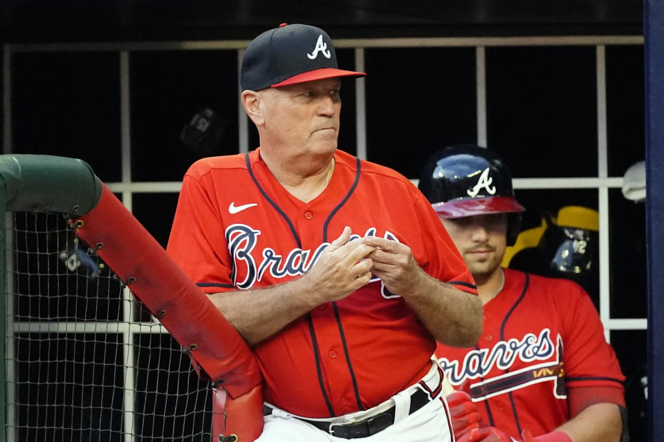 Atlanta Braves manager Brian Snitker looks on from the dugout during a baseball game against the Houston Astros Friday, Aug. 19, 2022, in Atlanta. (AP Photo/John Bazemore)